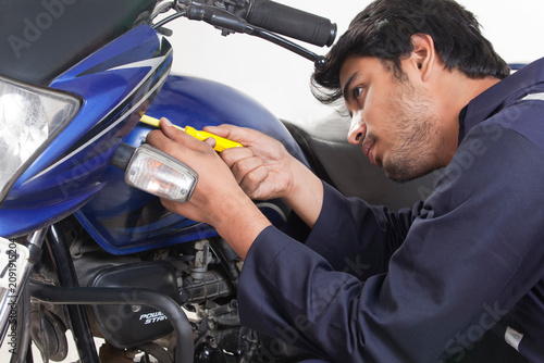 Mechanic working on motorcycle