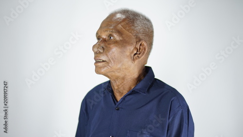 Принти на полотні Elderly Indigenous Man with Wrinkled Face and Gray Hair, Looking Sideways