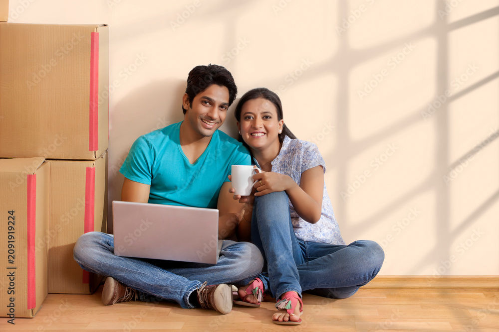Fototapeta premium Happy Couple having coffee at new home