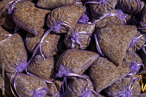 Bags of dried lavender displayed on a market table during daytime