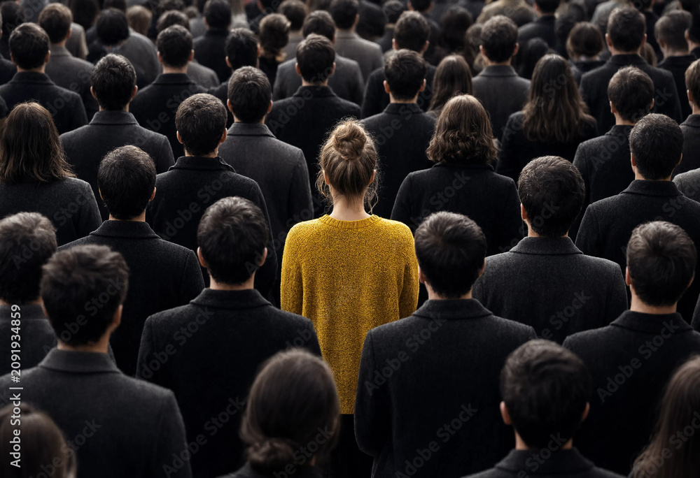 Obraz premium Woman in yellow stands out in a crowd of people wearing black
