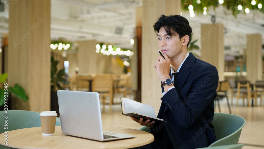 Fototapeta premium businessman company manager investor working on computer technology sitting at co working office desk. Busy professional businessman executive using laptop at work writing notes.