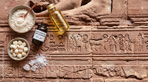 Hyper-realistic top down view of Egyptian black seed oil skincare on sandstone