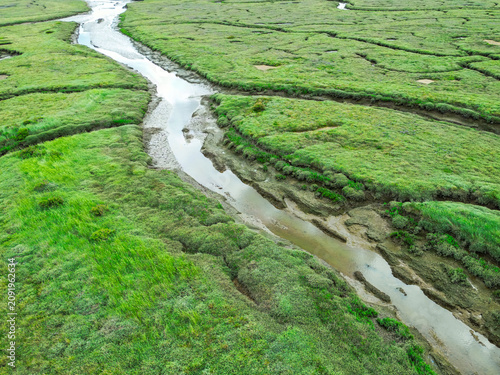 Dramatic aerial view of salt water marshes which are used as a flood plain as seen on the north Norfolk, UK coast. Deep mud and tidal forces make this area dangerous.
