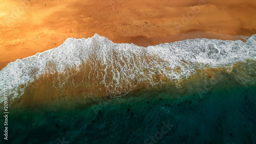 Photos Aerial view of the contrasting turquoise water meeting the sandy beach, while sh