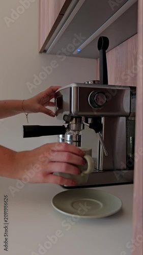 Making coffee and checking messages in a kitchen on a sunny morning