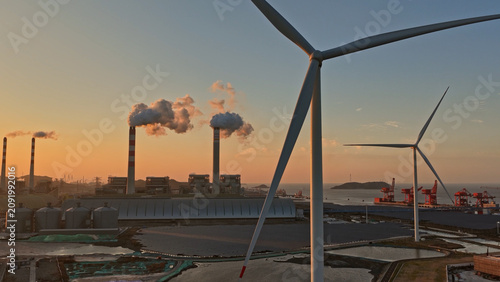 Aerial view industrial port landscape wind turbine solar panel power plant. Renewable eco energy facility integration, factory infrastructure. Sustainable station development. Shipping containers hub.