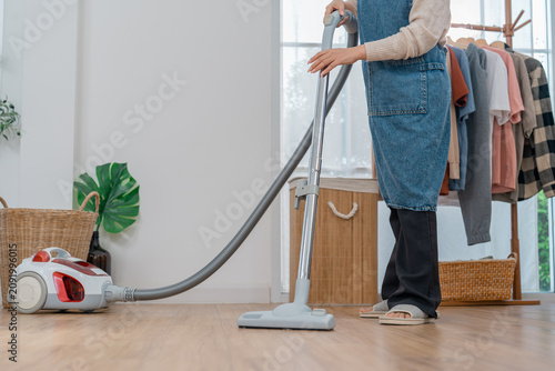 Canvastavla Vacuum cleaner woman cleaning floor home room appliance hose clothing rack woode