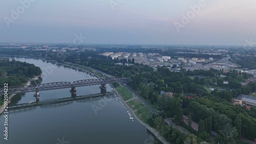 Po River bridge in Italy during a heatwave causing drought conditions, with low water levels revealing the dry riverbed and shorelines near Cremona and Piacenza