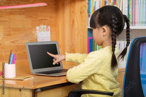 Fotografía cheerful Asian girl using laptop for online class at home, distance learning and e-education concept