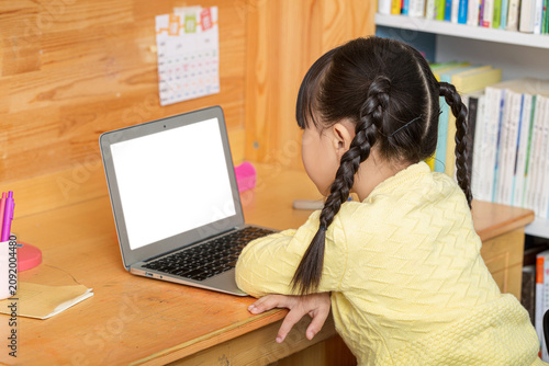 Bild auf Leinwand cheerful Asian girl using laptop for online class at home, distance learning and e-education concept