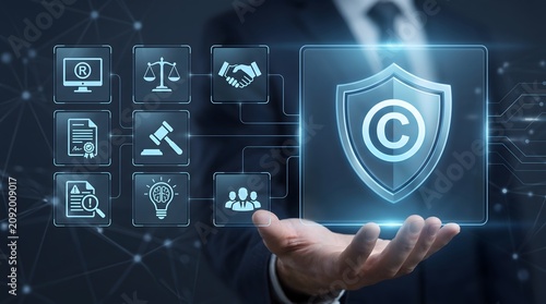 Intellectual property rights protection concept with businessman holding digital copyright shield and legal compliance icons