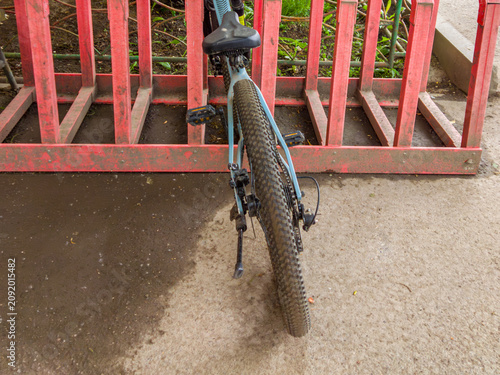 фотографія Bicycle parked near red bike rack outdoors