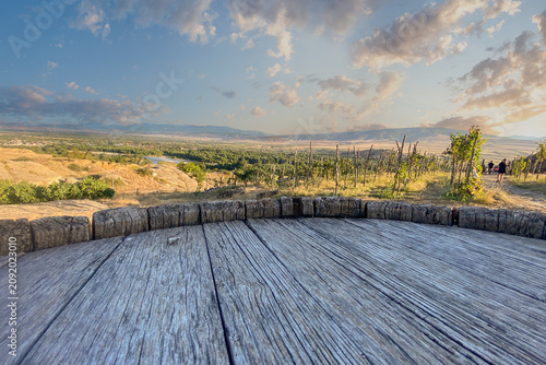 Canvastavla Empty space on top of wine barrel on summer vineyard and sunset sky with cloud b