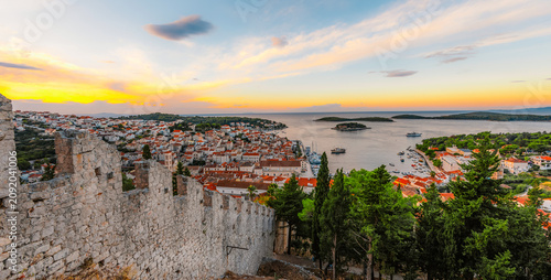 Tableau sur toile Hvar town and Pakleni Islands viewed from the medieval Spanish Fortress, golden hour over the Adriatic sea, Croatia