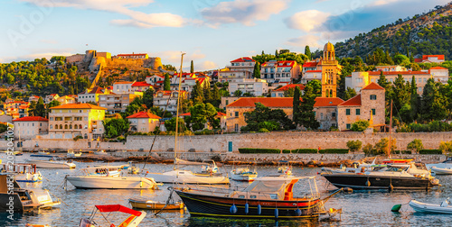 Fotografie Hvar town and Pakleni Islands viewed from the medieval Spanish Fortress, golden hour over the Adriatic sea, Croatia