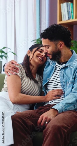 Kiss, couple and love on sofa with smile, bonding and gossip in living room. Embrace, happy man and woman with communication in house for relationship, relax or weekend in home lounge with support