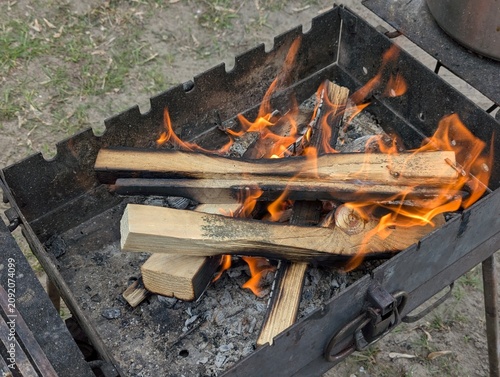 A fire burns in a fireplace, Fire to keep warm. Ready for preparing food on day nature tourist.