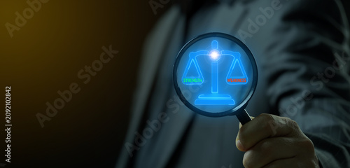 Obraz na płótnie Hand with magnifying glass searching glowing justice scales with strength and weakness text