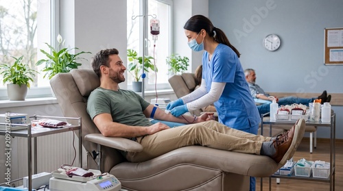 Volunteer Donating Blood at Modern Blood Donation Center, Nurse Collecting Blood for Transfusion