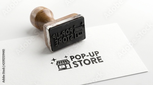 Pop-up store rubber stamp on white paper card, wooden handle stamper with black ink retail shop logo, minimalist business branding for boutique event
