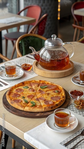 Authentic Italian pizza paired with warm tea inside stylish restaurant Vertical design created for business advertising pizzeria branding social media promotional materials