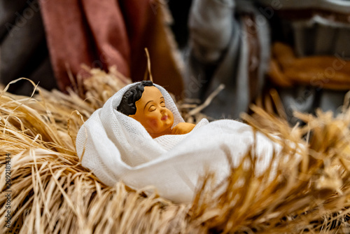 Obraz na plátně Jesus new born biblical figurine in a crib of christmas nativity scene