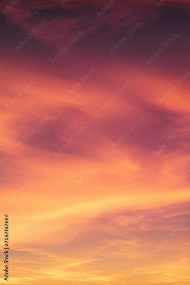 Fototapeta premium Colorful Sunset Sky with Orange Pink and Yellow Clouds Golden Hour Vertical Romantic Background