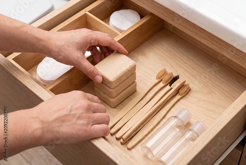 Sustainable Bathroom Supplies Organized in Wooden Drawer with Bamboo Toothbrush