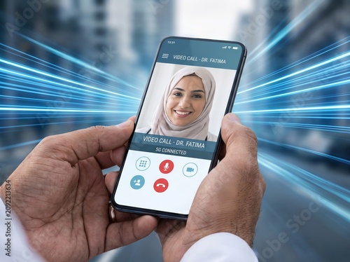 Smartphone video call with a Muslim female doctor for remote medical consultation over 5G network