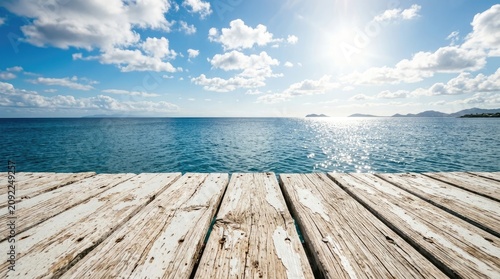 Coastal view from wooden dock with sparkling ocean and blue sky