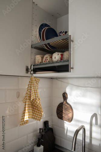 Bild auf Leinwand A kitchen towel hangs on a dish rack.