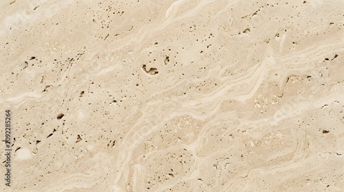 Close up texture of natural beige travertine stone with subtle patterns and holes