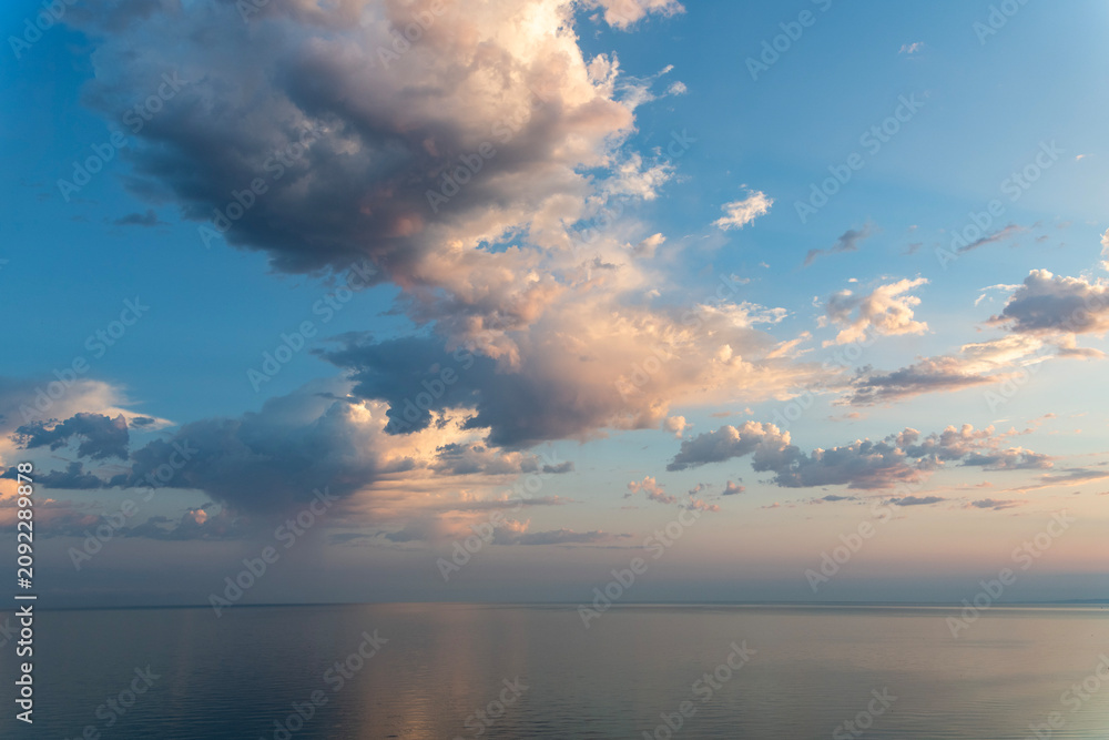 Fototapeta premium Colorful sunrise over the sea with orange clouds.