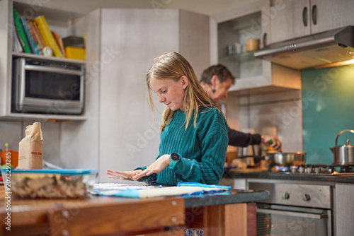 Young girl baking in the kitchen with her grandmother, learning and spending time together