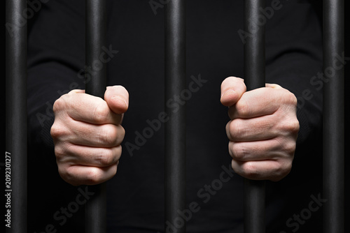 Prisoner Behind Bars. Close Up