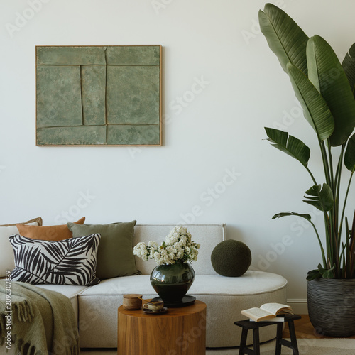 Minimalist Living Room with Sofa, Artwork, and Lush Green Plant for a Calm and Modern Interior Design