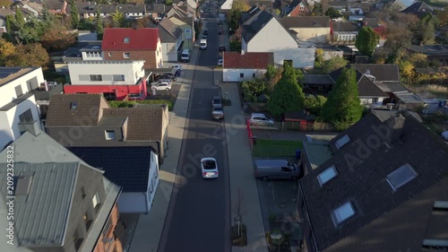 Residential District Germany. White car is driving throug the living District in West Germany. Low-rise buildings Aerial