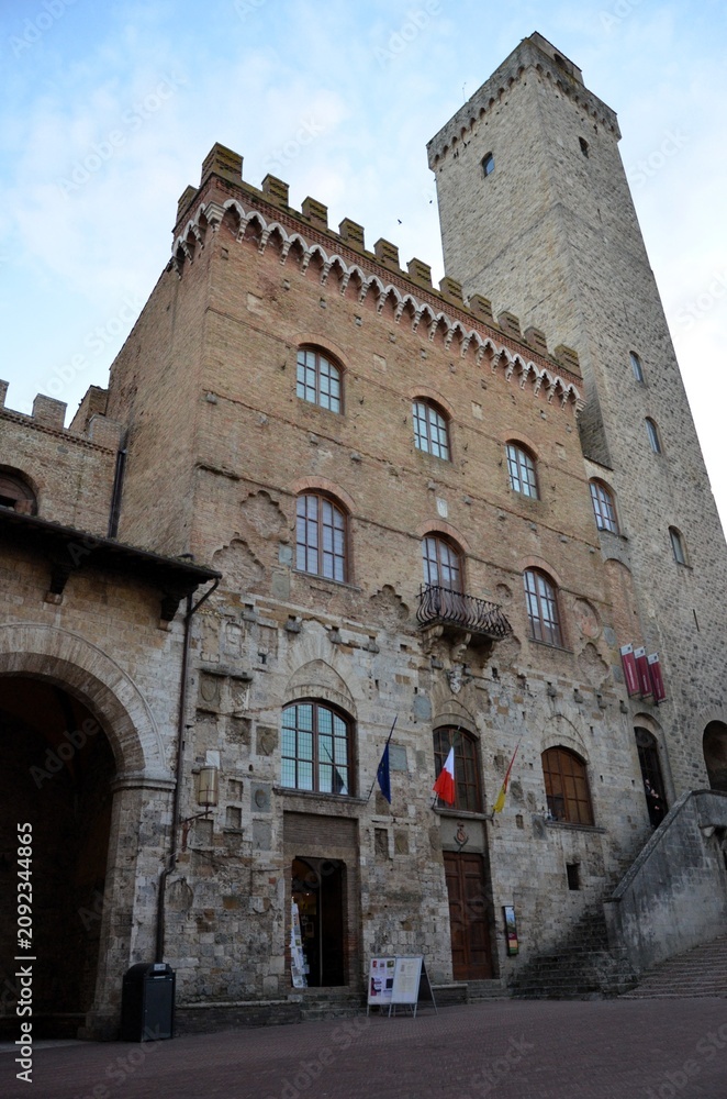 Fototapeta premium San Gimignano, Italy 03.04.2020: Town Hall (also known as the Palazzo del Popolo or Palazzo Nuovo del Podestà) and the Torre Grossa in San Gimignano