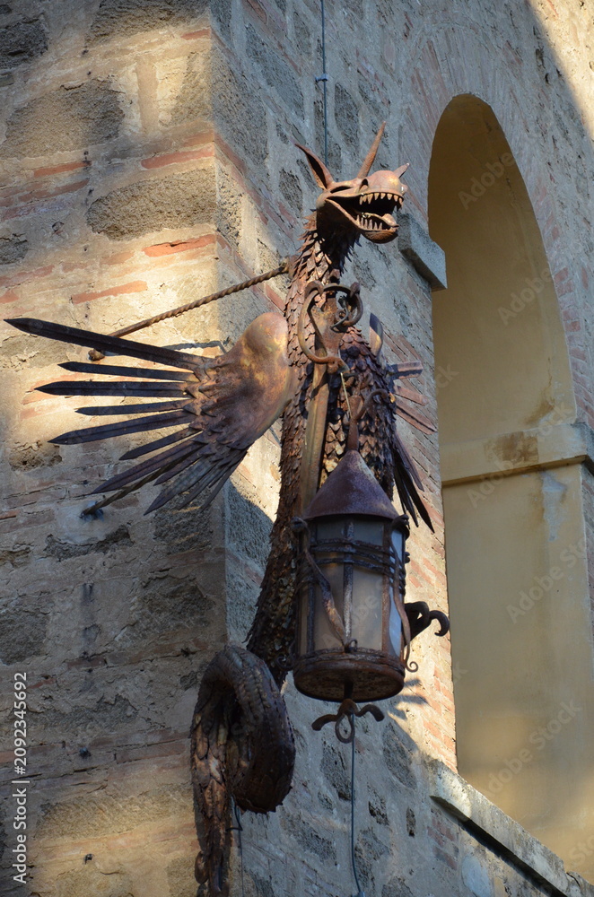 Fototapeta premium Castiglioncello, Italy 03.04.2020: Dragon-shaped sample holder or artistic lamp located at the Pasquini Castle in Castiglioncello.