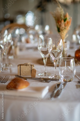 Elegant restaurant table setting with wine glasses and gift box