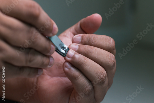 man hands maintaining hygiene by trimming nails at home as part of a self-care routine.