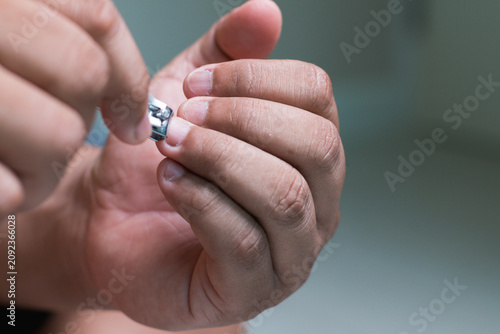 man hands maintaining hygiene by trimming nails at home as part of a self-care routine.