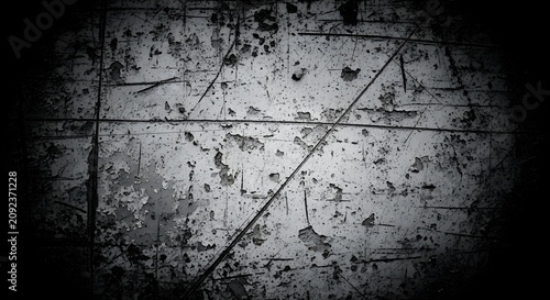 Grungy concrete wall with peeling paint and scratches in dark vignette style for industrial background.