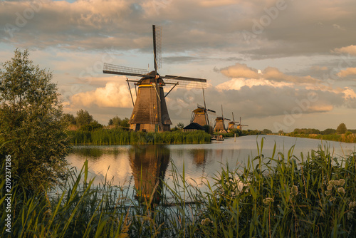 Картината върху платно Kinderdijk windmills reflecting in a canal at sunset, representing Dutch heritag