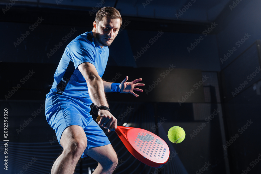 Obraz premium Padel Tennis Training Session with Racket and Ball in Indoor Court