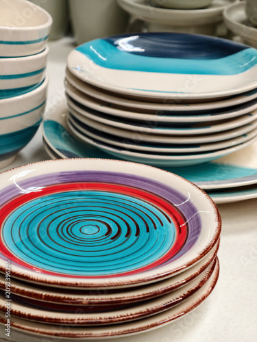 Plates on shelves in store, closeup of ceramic dishware for kitchen and household