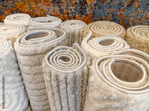 Fotografie Decorative fluffy home carpets in light and gray tones arranged in a superstore