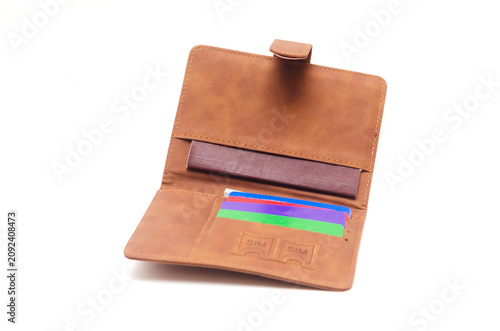 Open brown cover for passport and bank cards isolated on white background.