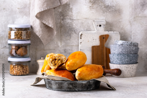 Obraz na plátně Traditional baked pies pirozhki with meat.